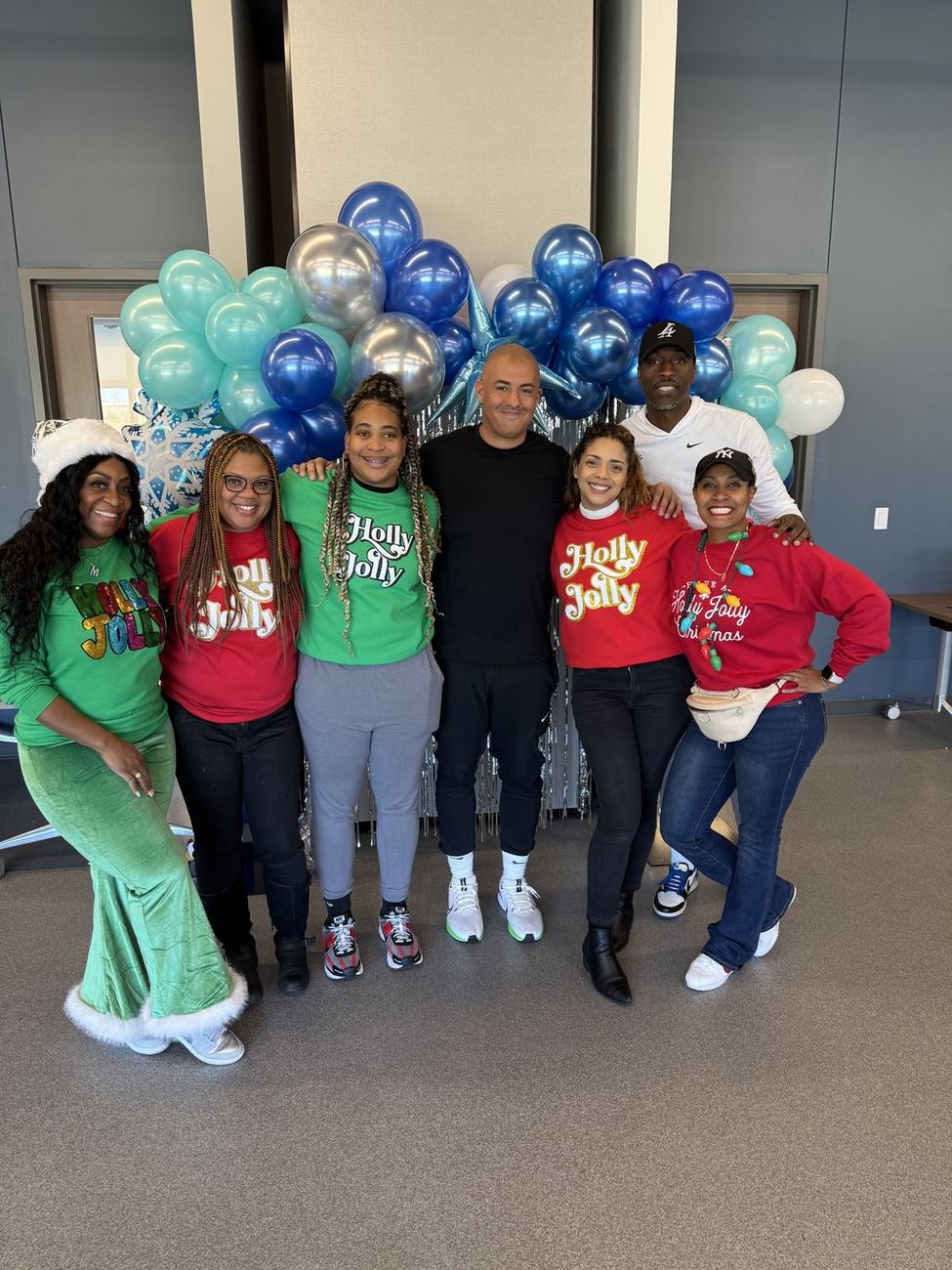 The Holly Jolly volunteer team with the balloon arch